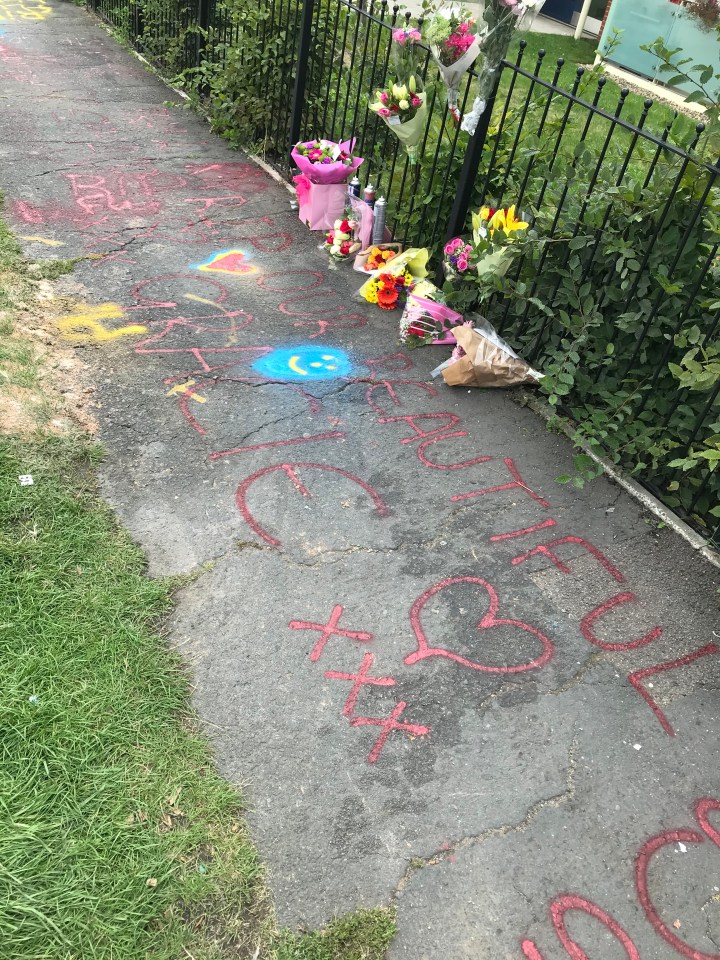 Flowers were left along the pavement along with messages spray painted in memory of the mum-of-two