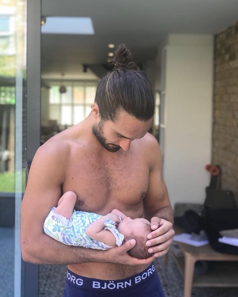 Seeing an image of a man with a baby, like this snap of Joe Wicks, 'triggers that feeling of seeing a man that’s worth mating with'