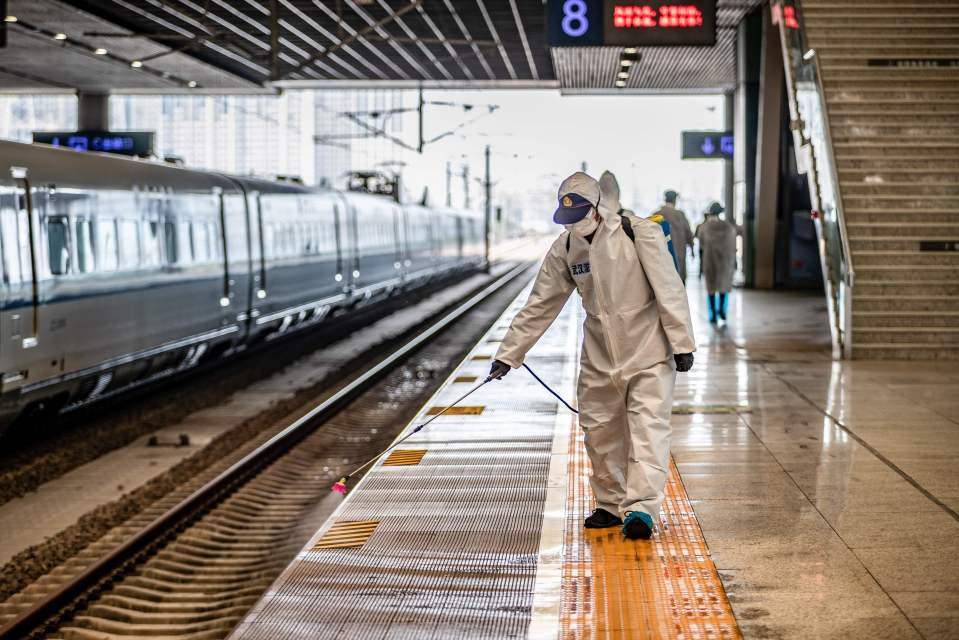 A staff member sprays disinfectant at Wuhan Railway Station in Wuhan in China's central Hubei province