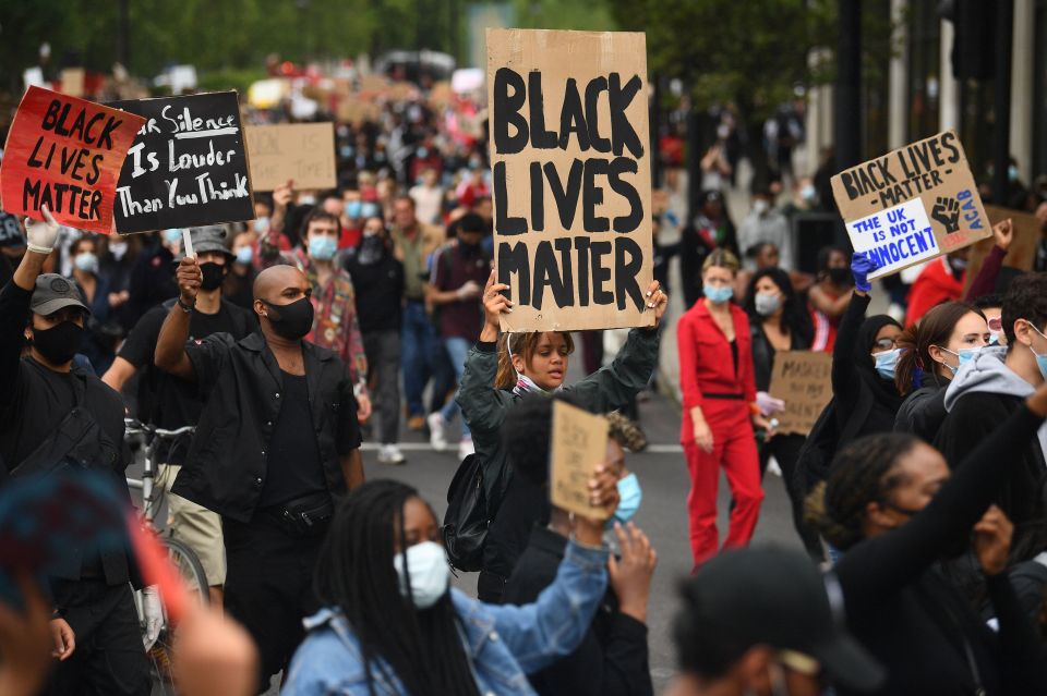 Activists in face masks held placards reading "I can't breathe" to echo the final words of George Floyd