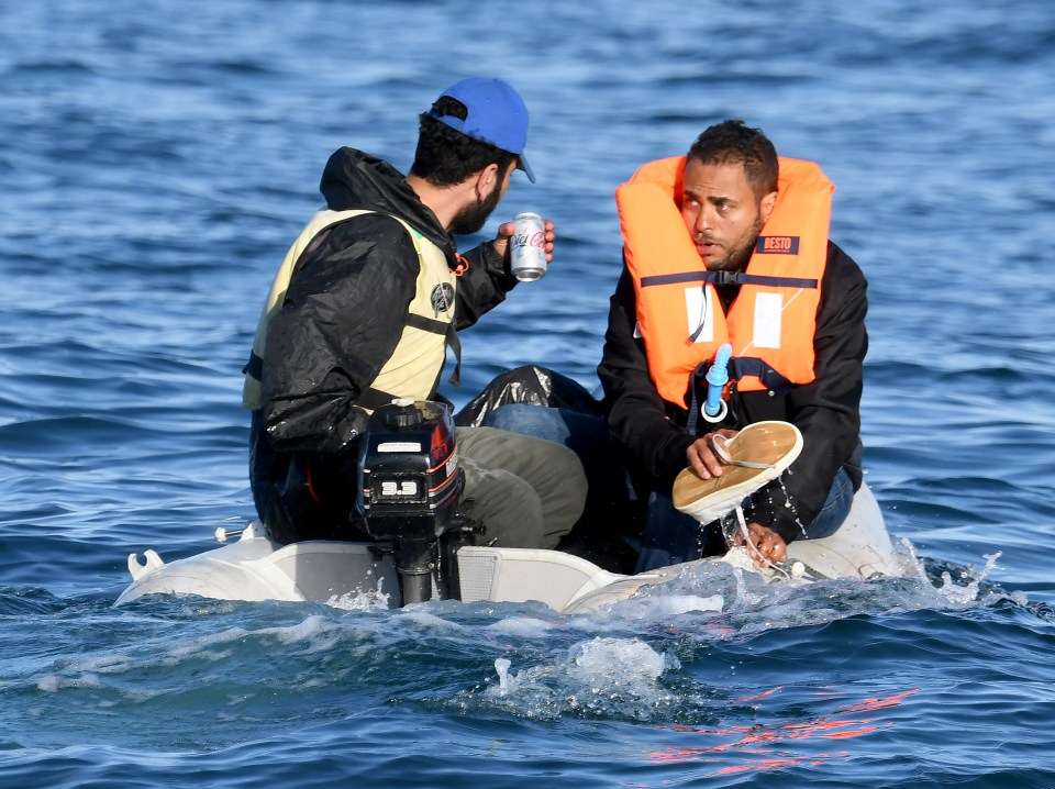 A migrant crossing the Channel is using a plimsoll to bail water