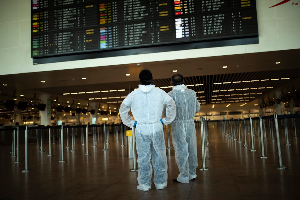 Passengers in full protective gear at the Zaventem international airport in Brussels