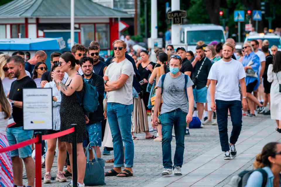 People queue up to board a boat at Stranvagen in Stockholm on July 27