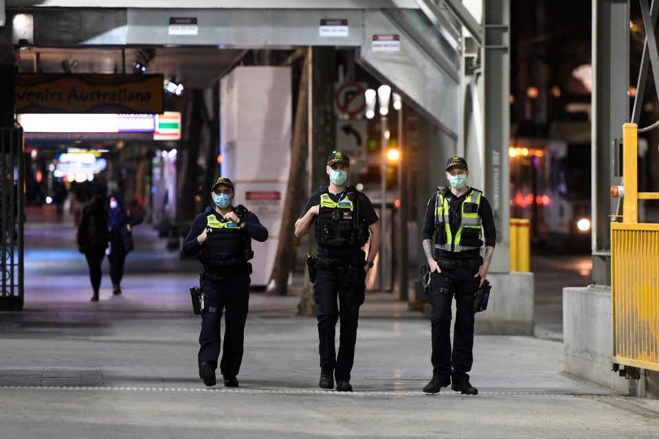 Cops patrol the streets of Melbourne to enforce a curfew