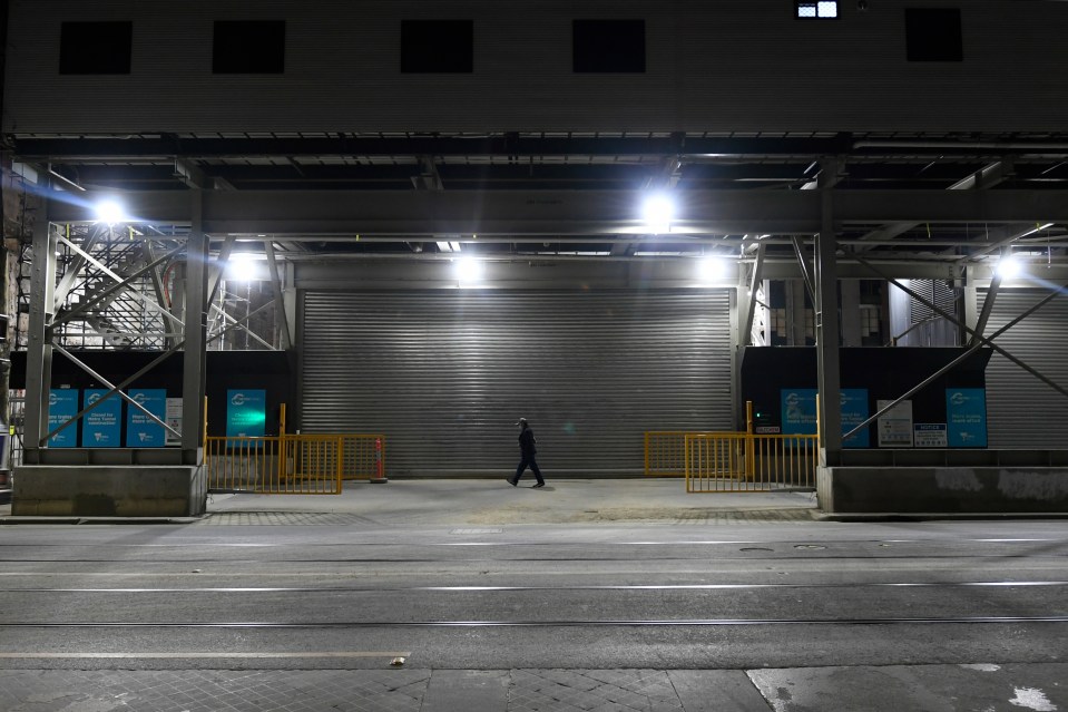 A man walks down Swanston Street after the curfew was announced yesterday