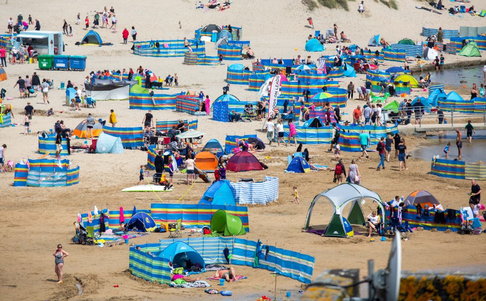 Tourists flock to the Perranporth beach in Cornwall