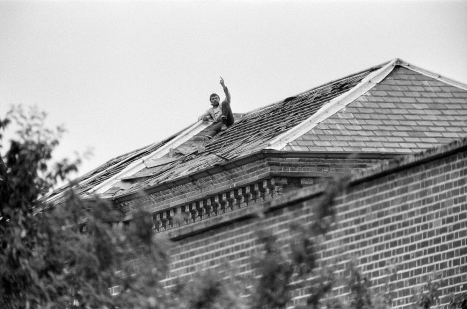 Bronson – who has changed his name to Charles Salvador in tribute to artist Salvador Dali – is pictured staging a rooftop protest at the hospital in 1983