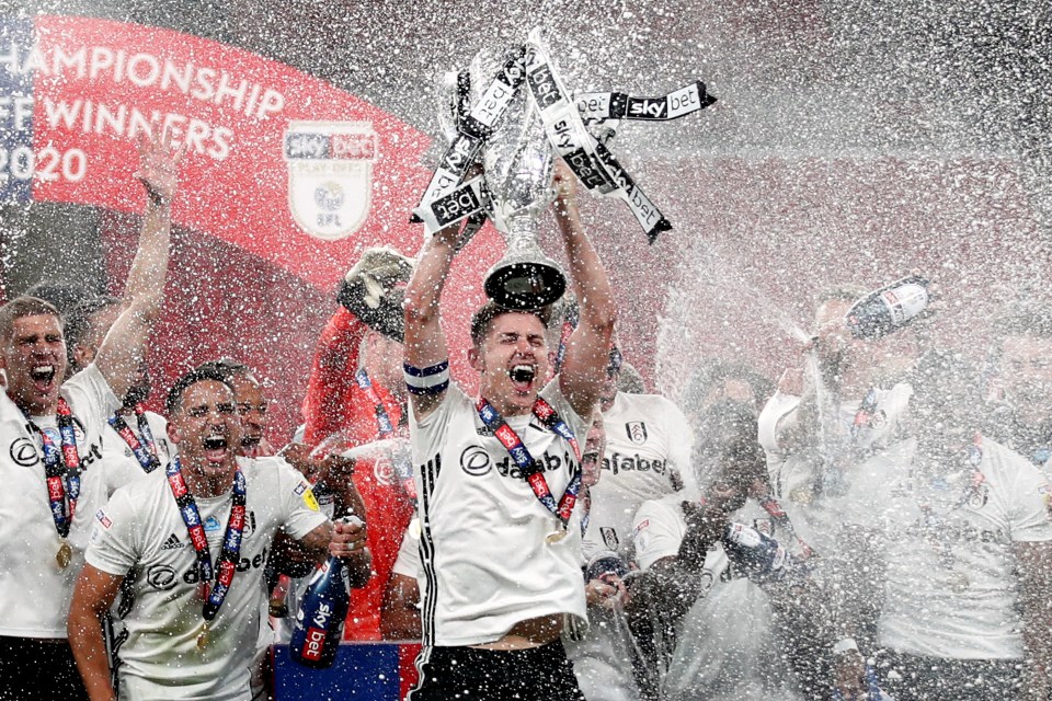 Cairney lifts the Championship play-off trophy aloft for the second time in three years