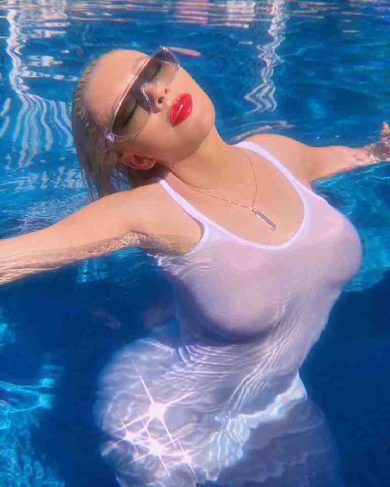 Christina Aguilera looked sensational in white as she cooled off in the pool