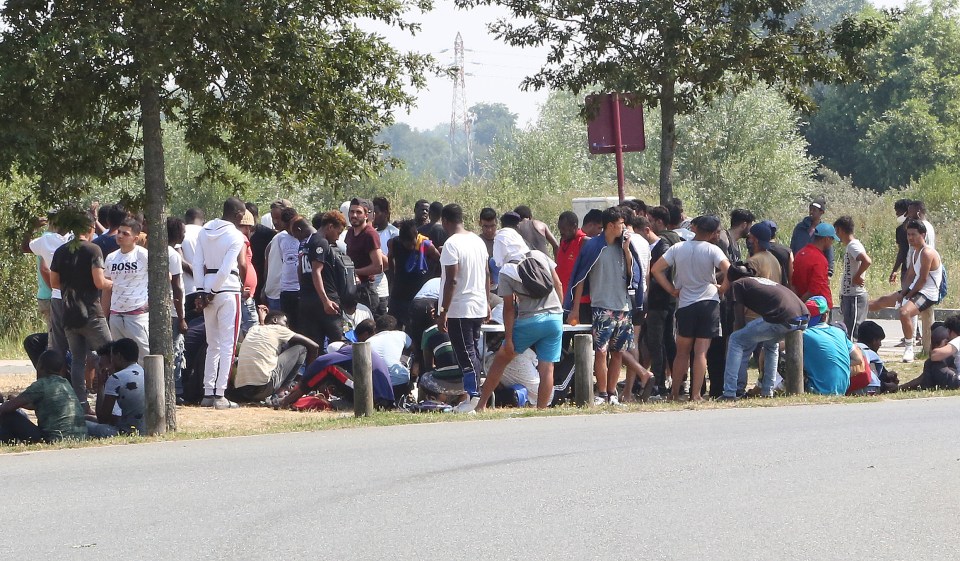 Hundreds of migrants were pictured waiting for their chance to cross the Channel to the UK