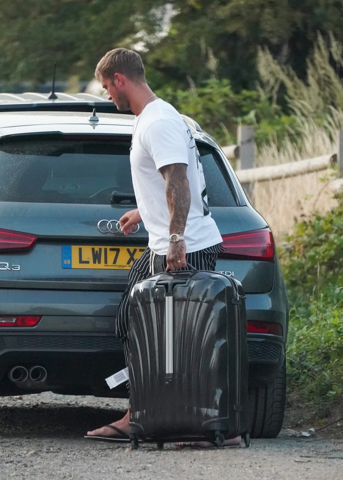 Dan got the luggage out of the car after arriving back home