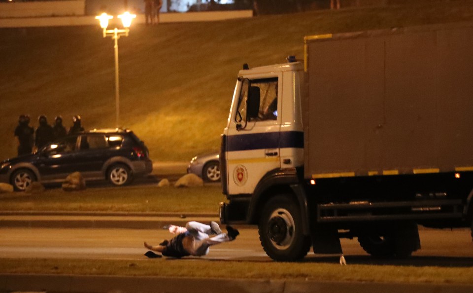 A police truck hits an opposition activist during a protest after polling stations closed