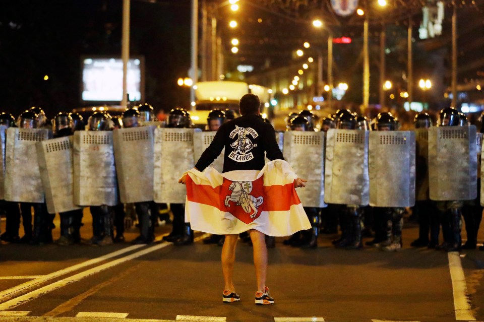 One protester faces down a line of riot police