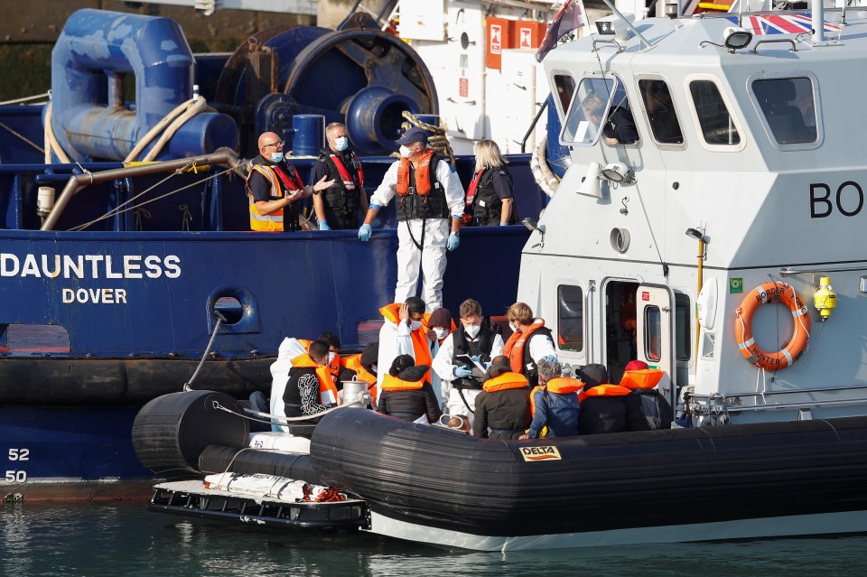 A Border Force boat carrying migrants arrives at Dover