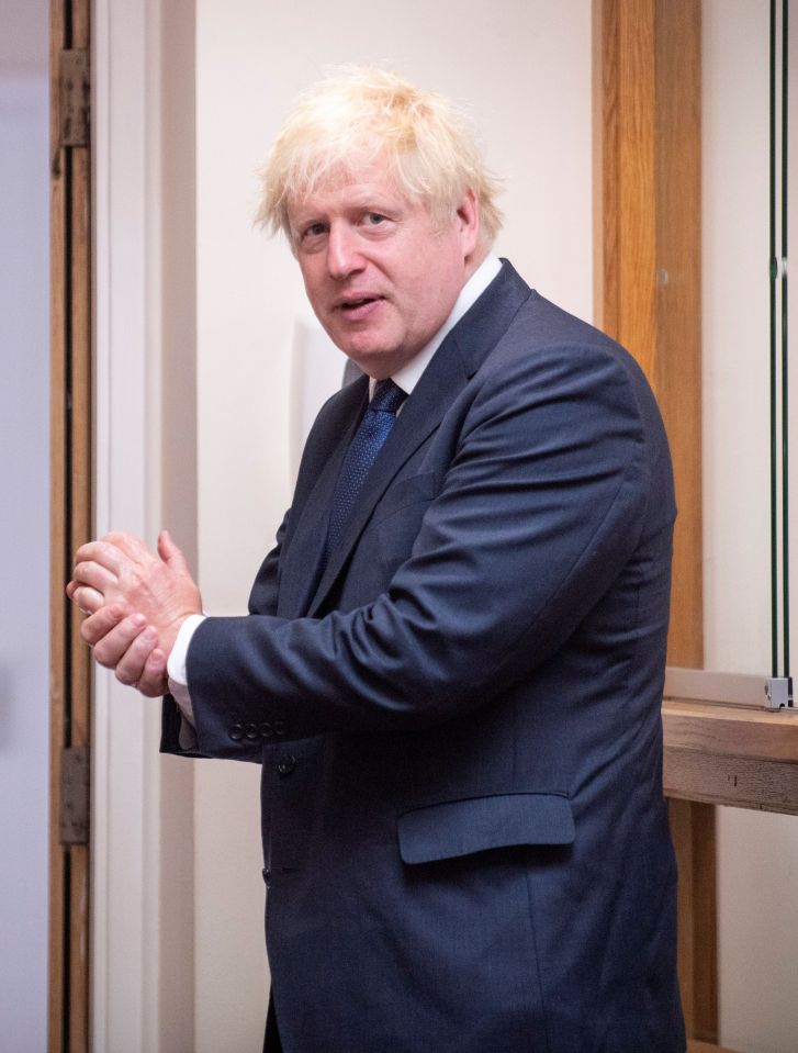 Boris Johnson uses hand sanitiser during the school visit today