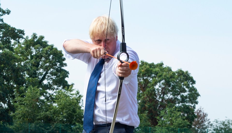 Boris Johnson takes aim during an archery class at an East London school today