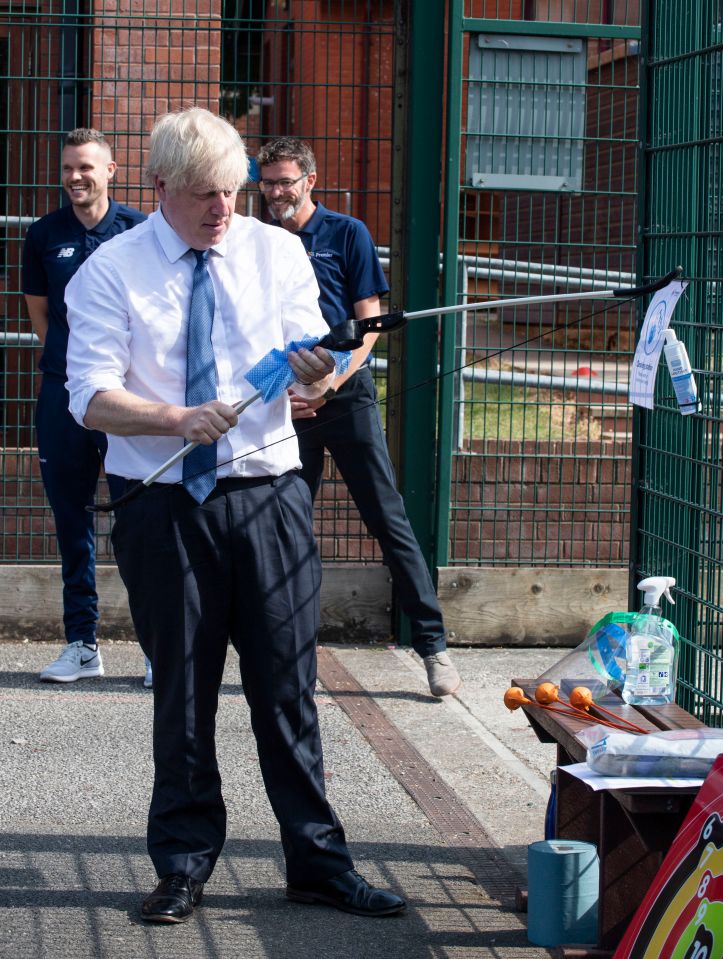 Boris wipes down the bow during his archery session today