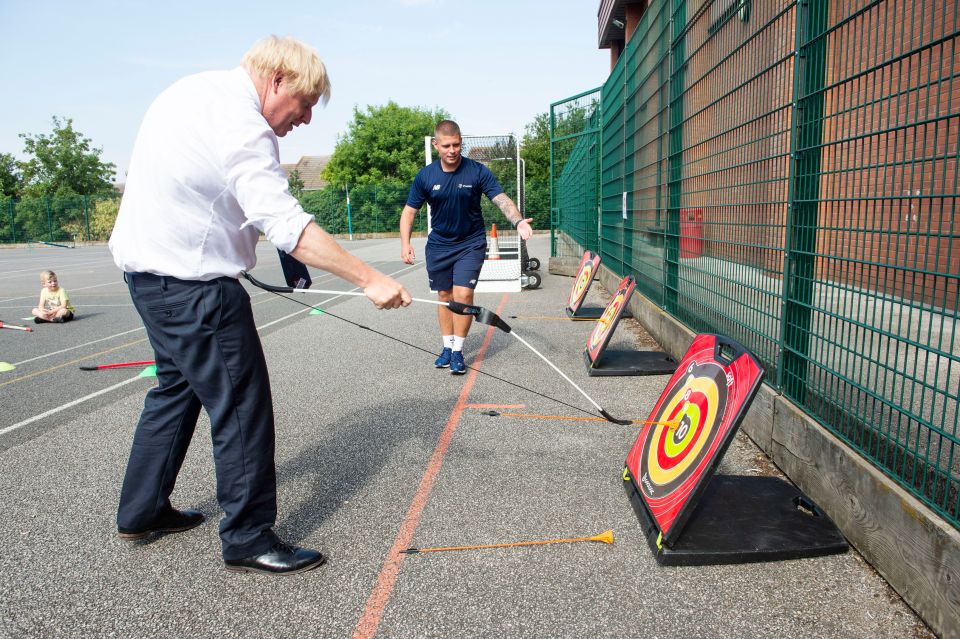 Mr Johnson checks his shot during the archery lesson