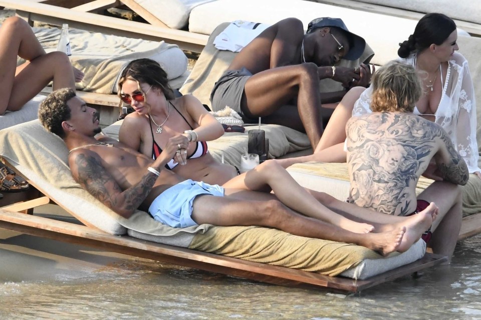 The pair looked loved-up as they relaxed on sun loungers