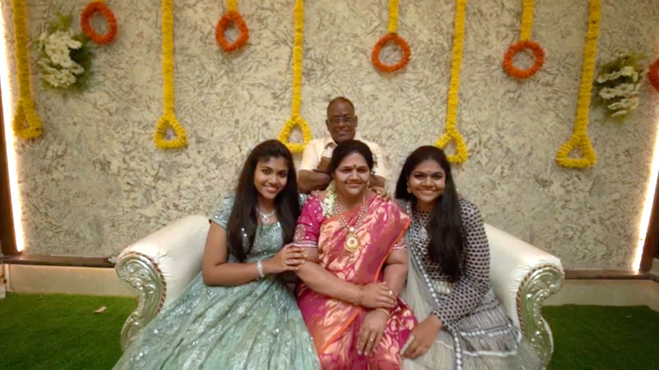 Shrinivas and his two daughters Anusha, 25, and Sindhusha, 22, pose with the life-like replica of Madhavi