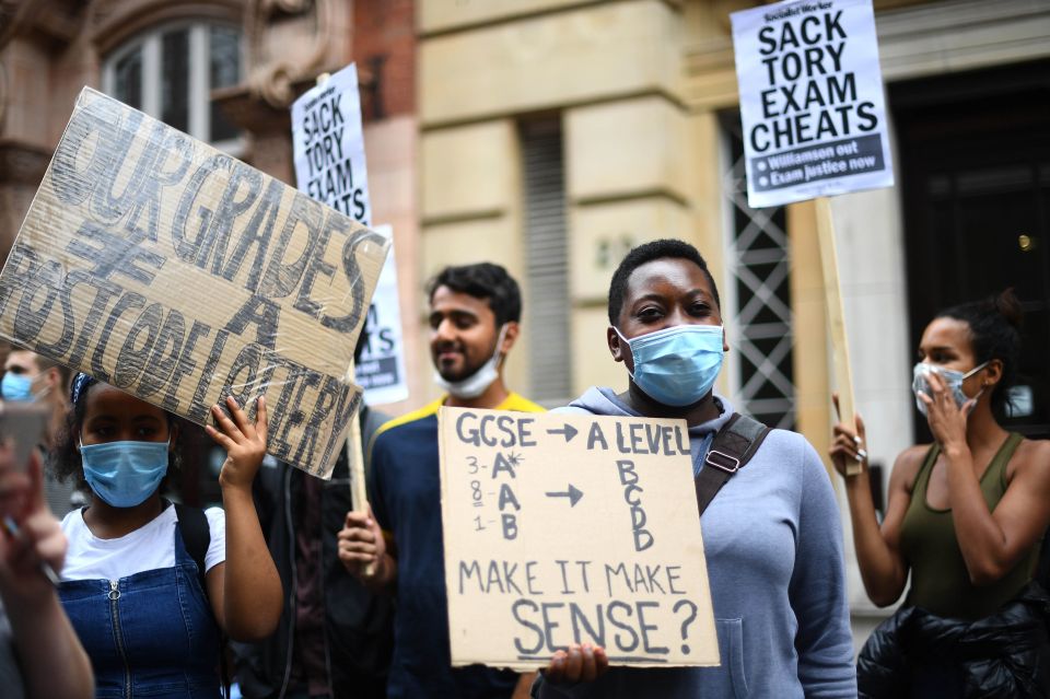 Many held placards highlighting the inconsistency of the results they received