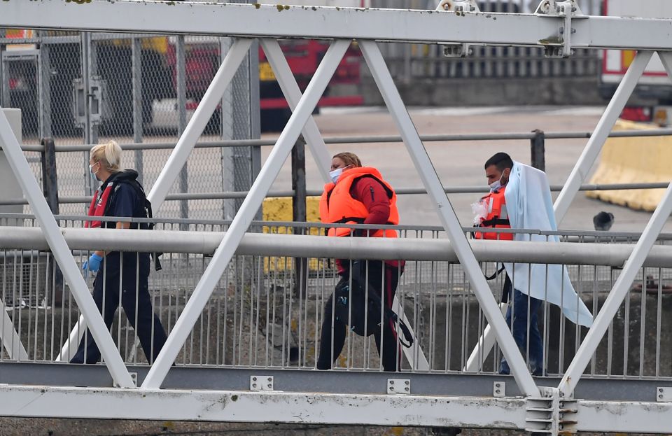 Wearing life jackets, people were seen arriving on dry land