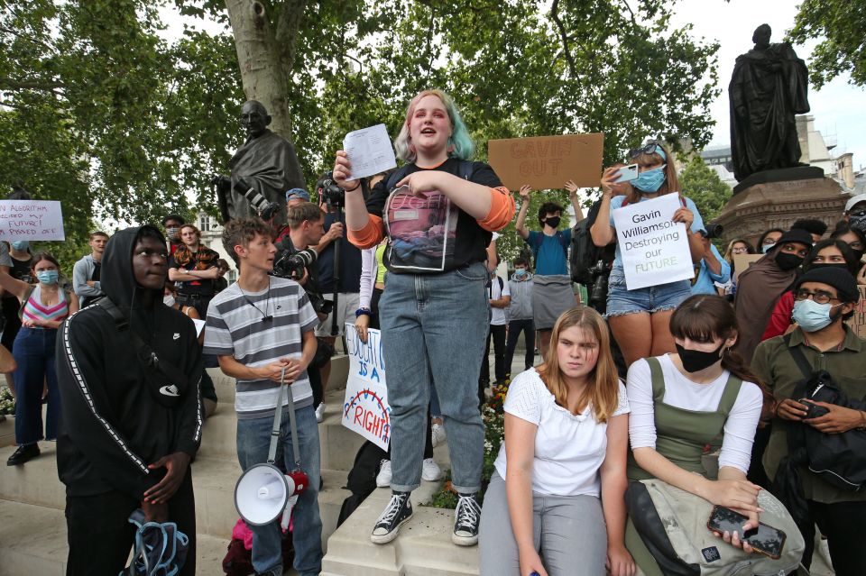 Olivia Styles, 18, from Basingtoke, holds up her A-level results during peaceful protest in Parliament Square, London