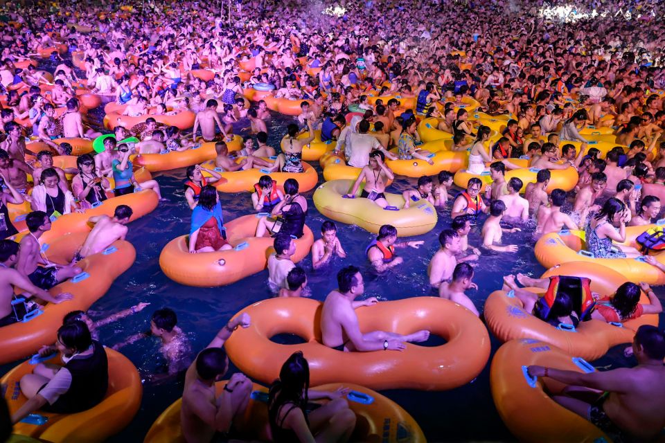 Hundreds cram into a swimming pool in Wuhan in August