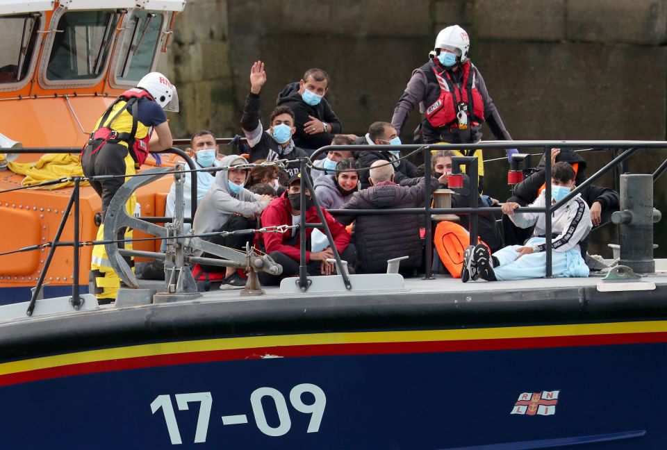 A lifeboat filled with migrants, including kids, arriving at Dover