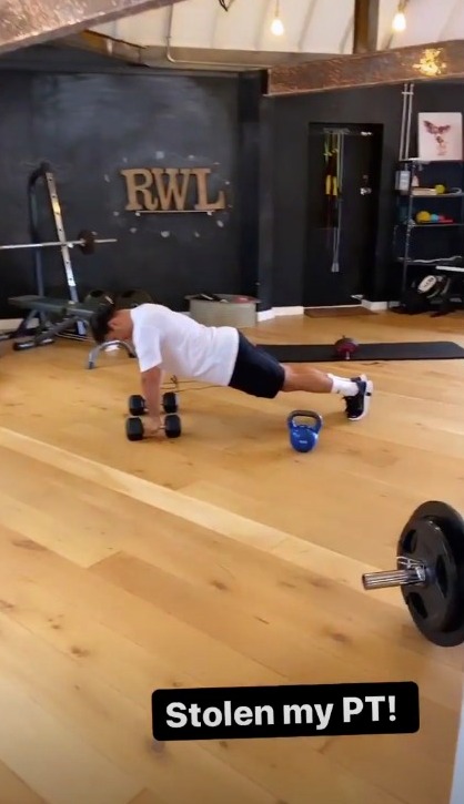 Lucy spoke to the camera while the former Corrie star performed dumbell push-ups