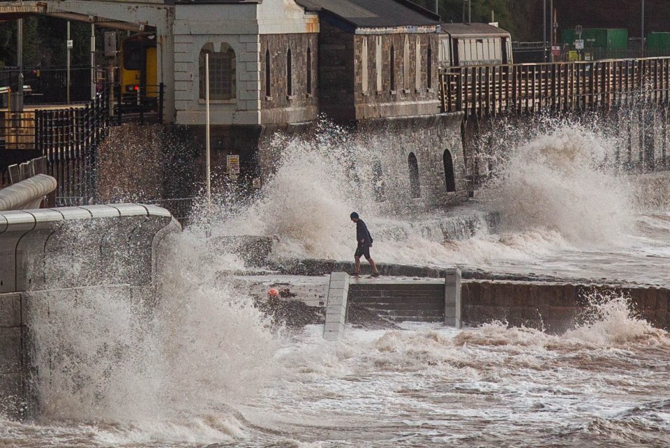 Waves crash into the new seawall at the Dawlish seafront in Devon