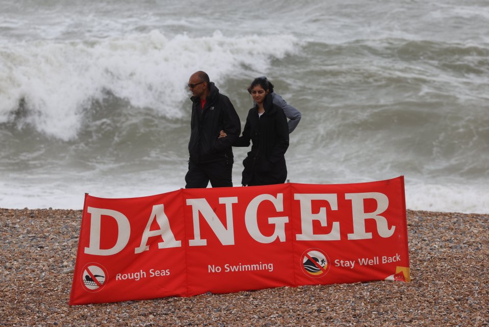 Danger signs warn people not to enter the water amid rough seas