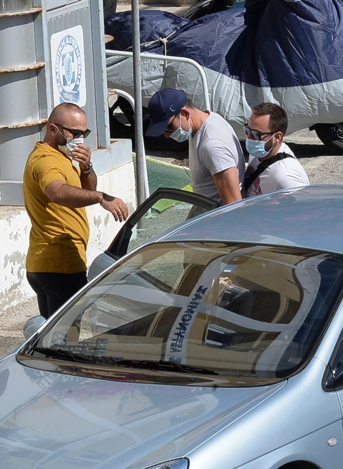 Maguire was pictured getting out of a police car wearing a cap and mask today