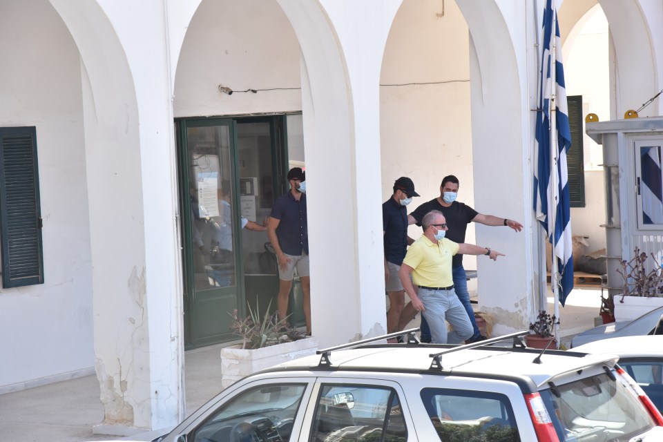 Members of the group are led out of a court in Syros today