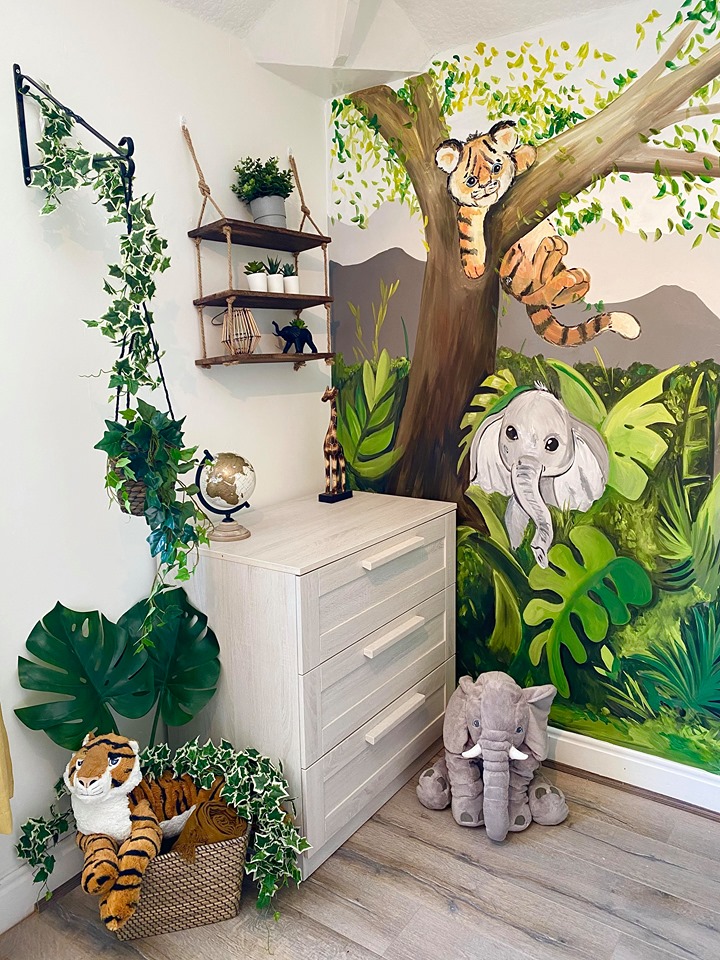 Now the room is a jungle wonderland, with stuffed animals and an impressive mural