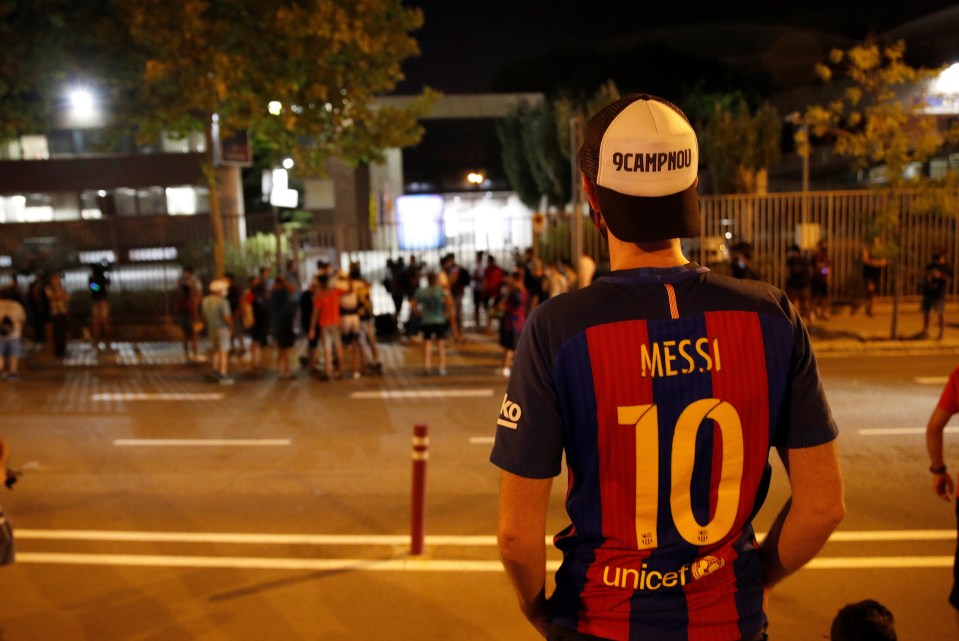 One fan looks on wearing a 'Messi 10' shirt in honour of his hero