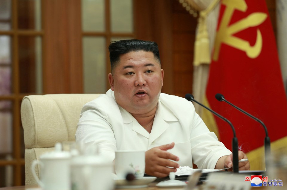 Kim Jong-un smokes a cigarette as he discusses the health crisis posed by coronavirus in more images released this week