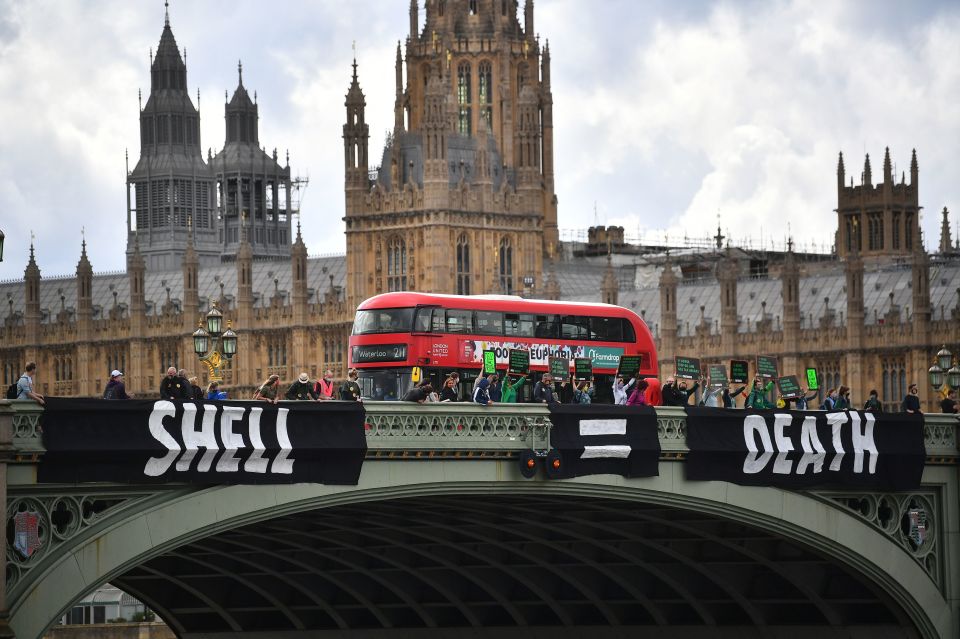 Activists from Extinction Rebellion unfurl a banner on Westminster Bridge, London