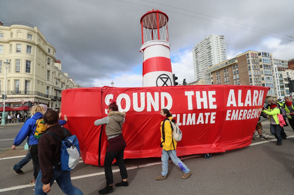 Activists from Extinction Rebellion manoeuvre a "Lightship" named after climate activist Greta Thunberg, along Brighton seafront en route to London