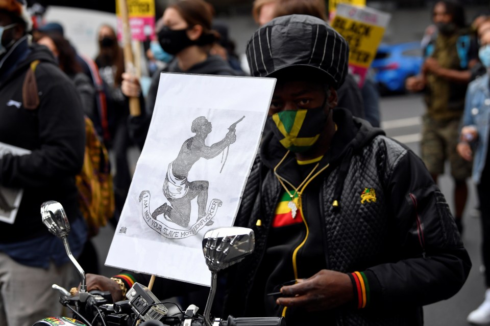 An anti-racism activist carries a placard as he takes part in the Millon People March