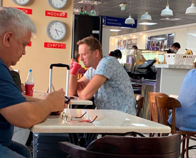 Alexei Navalny was snapped drinking from a cup at a cafe at Tomsk airport in Russia before catching his flight, during which he began experiencing horrific pain