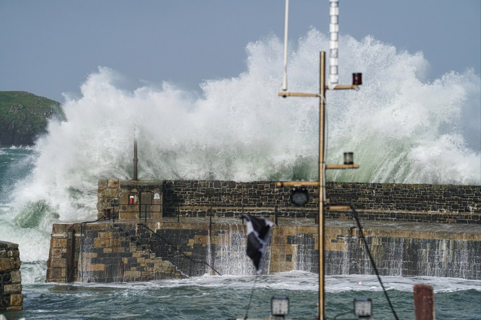 Waves cased by Storm Ellen strike the harbour at Mullion Cove, Cornwall yesterday