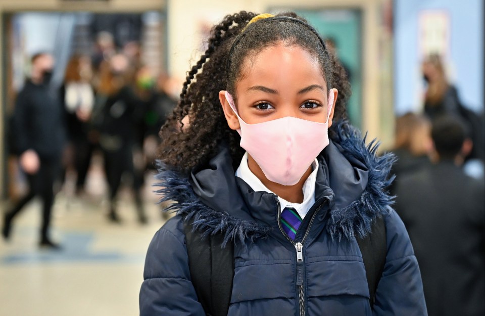 A pupil at Rosshall Academy wears a colourful face covering as new rules are enforced today