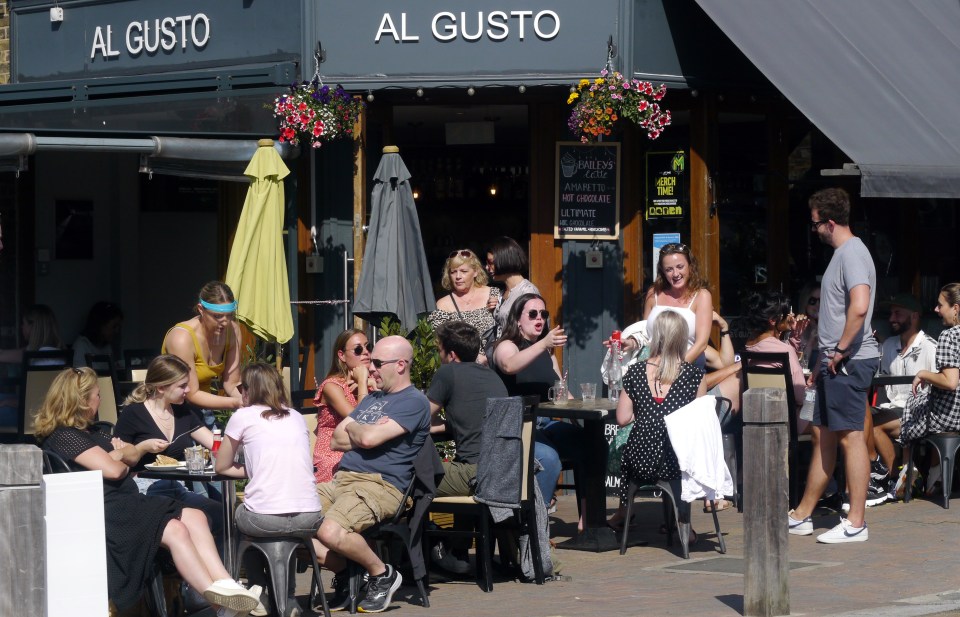 Brits soak up the sun in London as they enjoy a drink outdoors