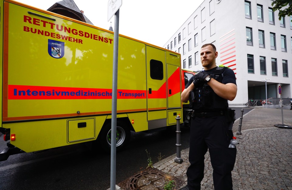 German security stands in front of an ambulance which transported Russian opposition leader Alexei Navalny to Charite Hospital