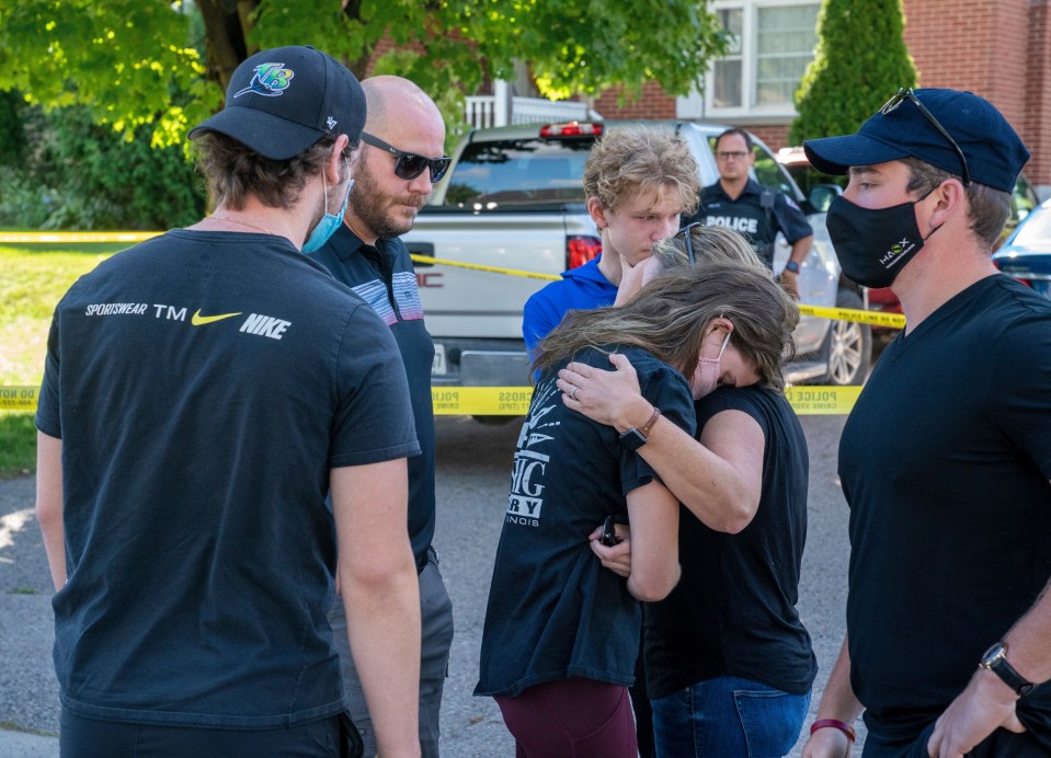 Family members and neighbours grieve at the scene