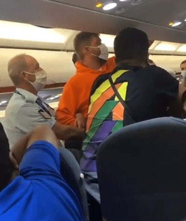 Mr Torun removes his luggage as Greek cops watch on during the flight