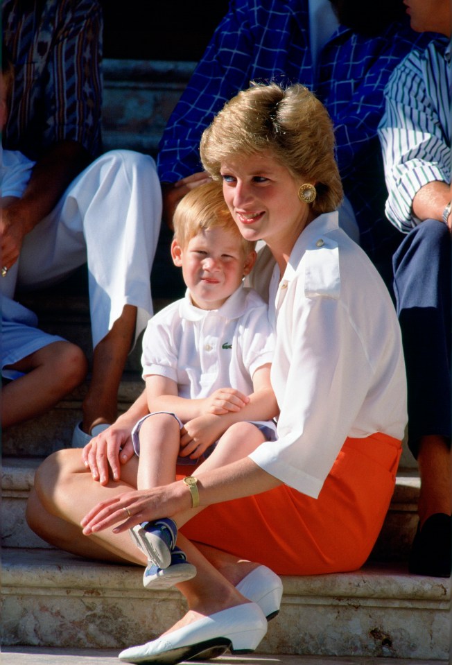 princess diana sits on the steps with a young boy