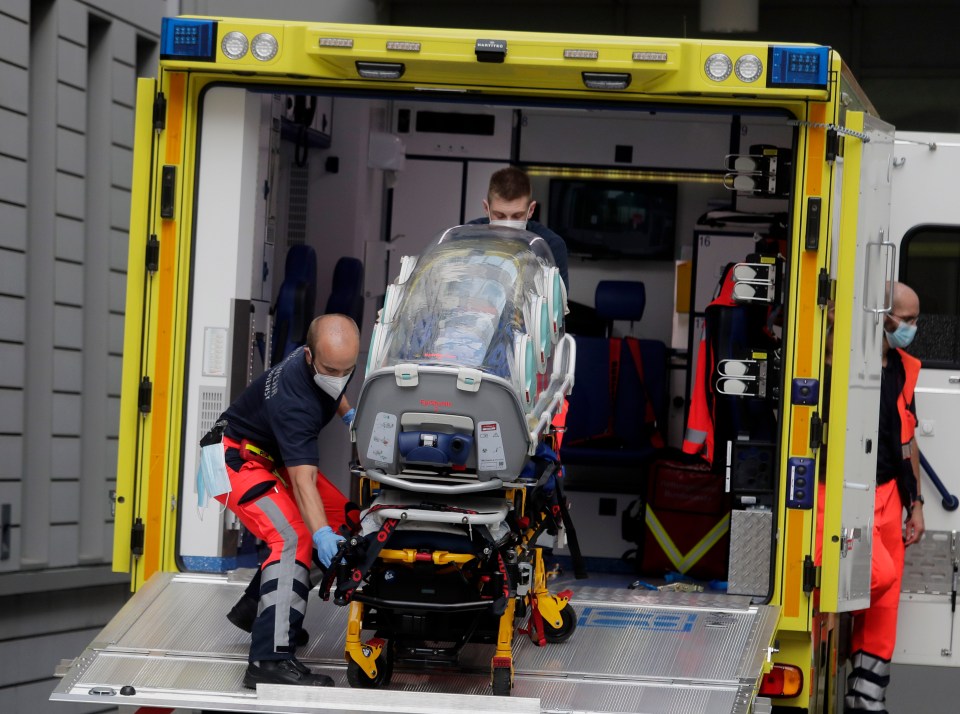 A bubble stretcher is carried back into an ambulance which is believed to have transported Alexei Navalny