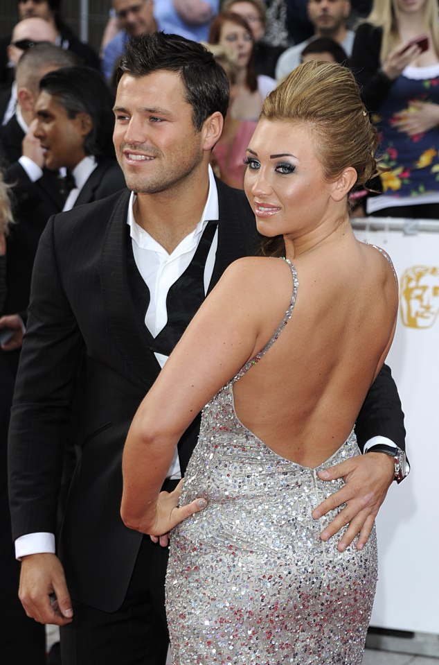 Dapper-looking Mark with his hand on Lauren's famous rear on a red carpet